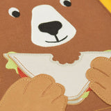 Close up of the playful brown bear eating a sandwich patch on the Frugi 100% organic cotton yellow short sleeve t-shirt