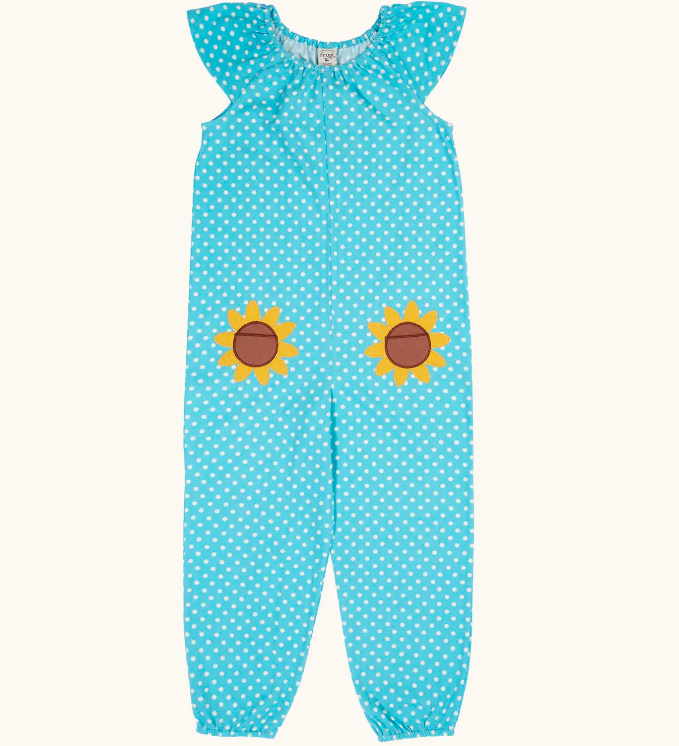 Frugi 100% organic cotton Dora playsuit in blue with white dots and sunflower patches on the front. Showing elasticated neck line