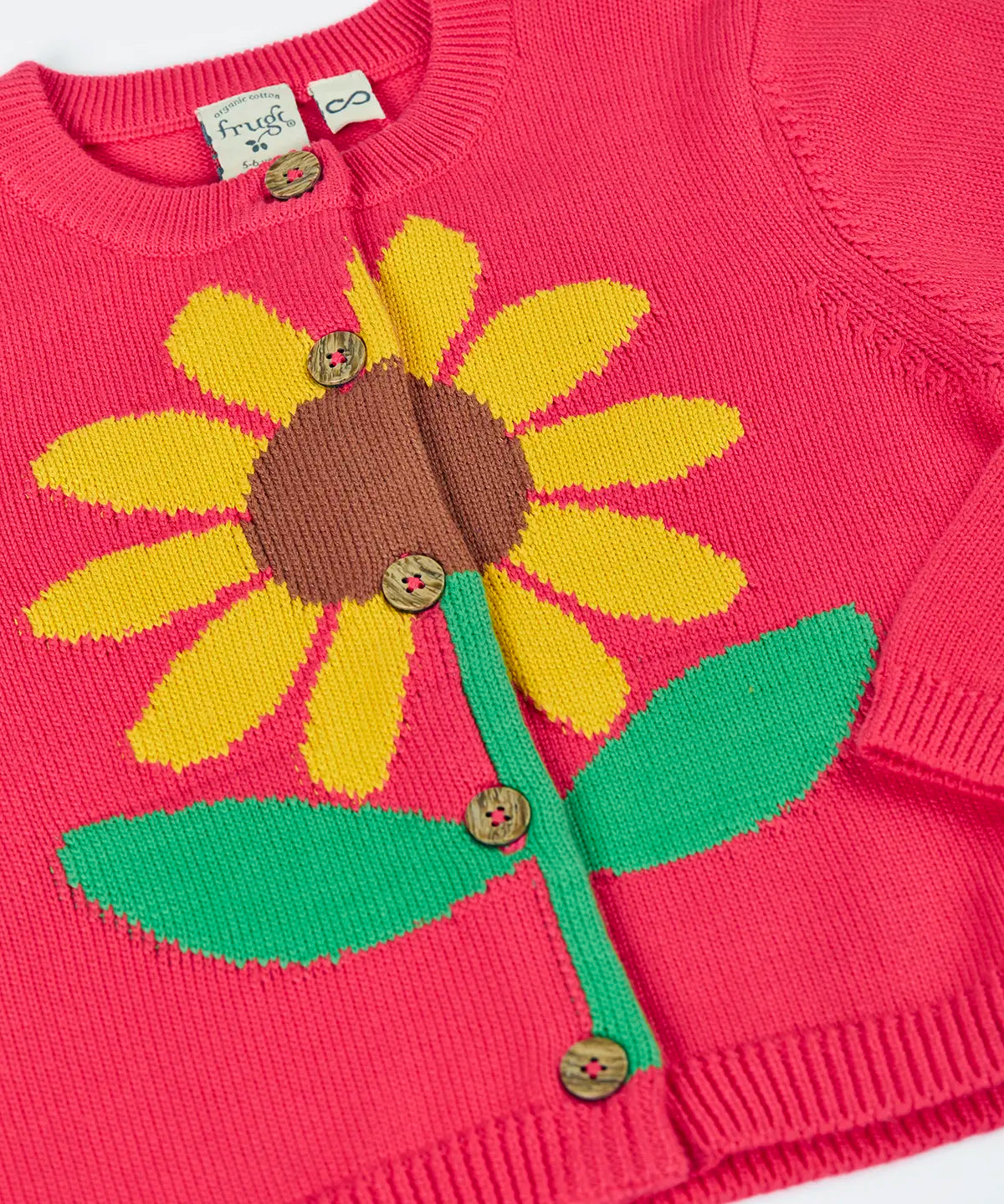 Frugi 100% organic cotton Ella cardigan in pink laid flat showing sunflower design on the front and button fasteners