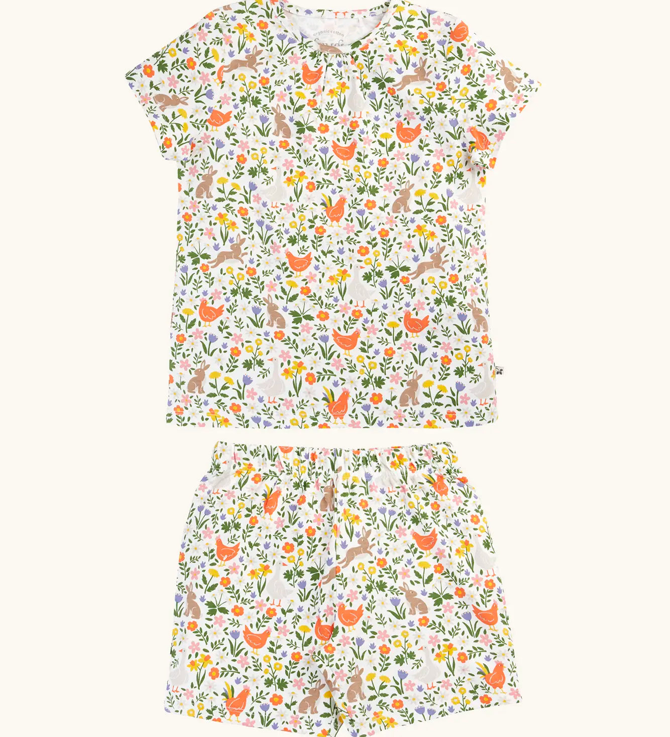 Frugi 100% organic cotton fawn pj set in white with a repeating floral ,chicken and rabbit print on the short sleeve top and shorts