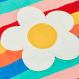 Close up of the white daisy patch on the Frugi 100% organic cotton short sleeve Fiona t-shirt in rainbow stripes 