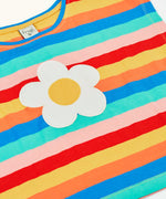 Frugi 100% organic cotton short sleeve Fiona t-shirt in rainbow stripes laid flast showing the white daisy patch on the front