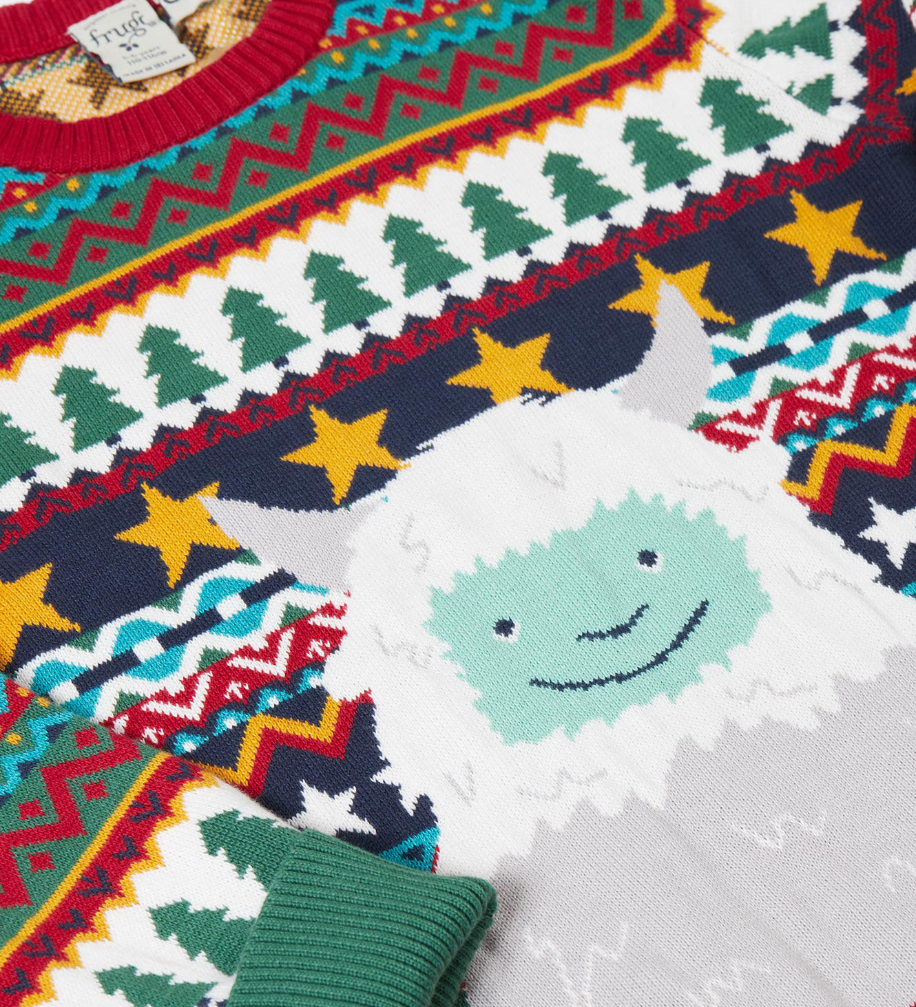 A close up of the cute playful yeti design on the Frugi forest fairisle/yeti jumper available at Babipur. 