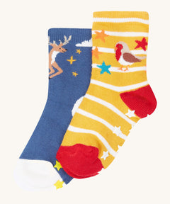 Frugi grippy 2 sock multipack in festive pals available at Babipur.  A pair of GOTS organic socks in a blue with reindeer design and a yellow/white stripe with robin design. Socks features small grip panels on the heel in a shape of stars