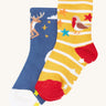 Frugi grippy 2 sock multipack in festive pals available at Babipur.  A pair of GOTS organic socks in a blue with reindeer design and a yellow/white stripe with robin design. Socks features small grip panels on the heel in a shape of stars