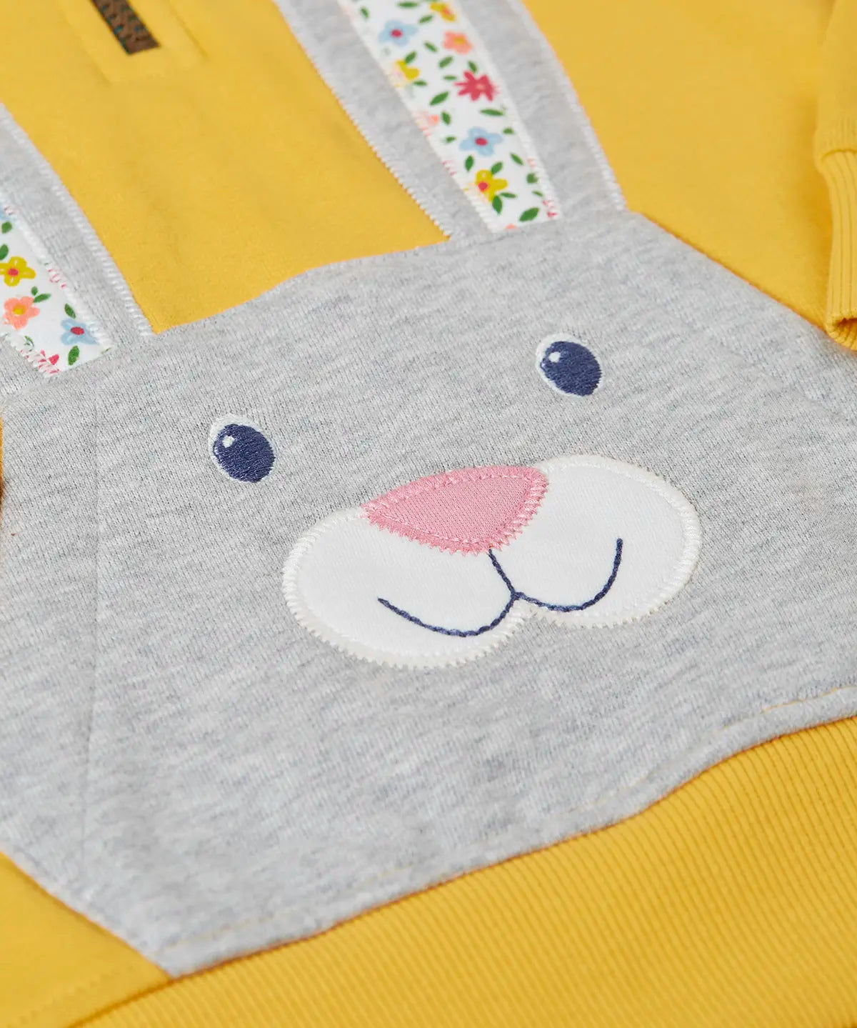 Close up of rabbit patch pocket on the front of the Frugi 100% organic cotton yellow hoodie 
