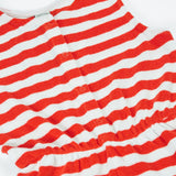 Frugi Harlyn towelling playsuit in red and white stripes laid flat showing front popper fasteners