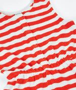 Frugi Harlyn towelling playsuit in red and white stripes laid flat showing front popper fasteners