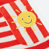 CLose up of the side pocket on the Frugi Harlyn towelling playsuit in red and white stripes showing sun patch detail