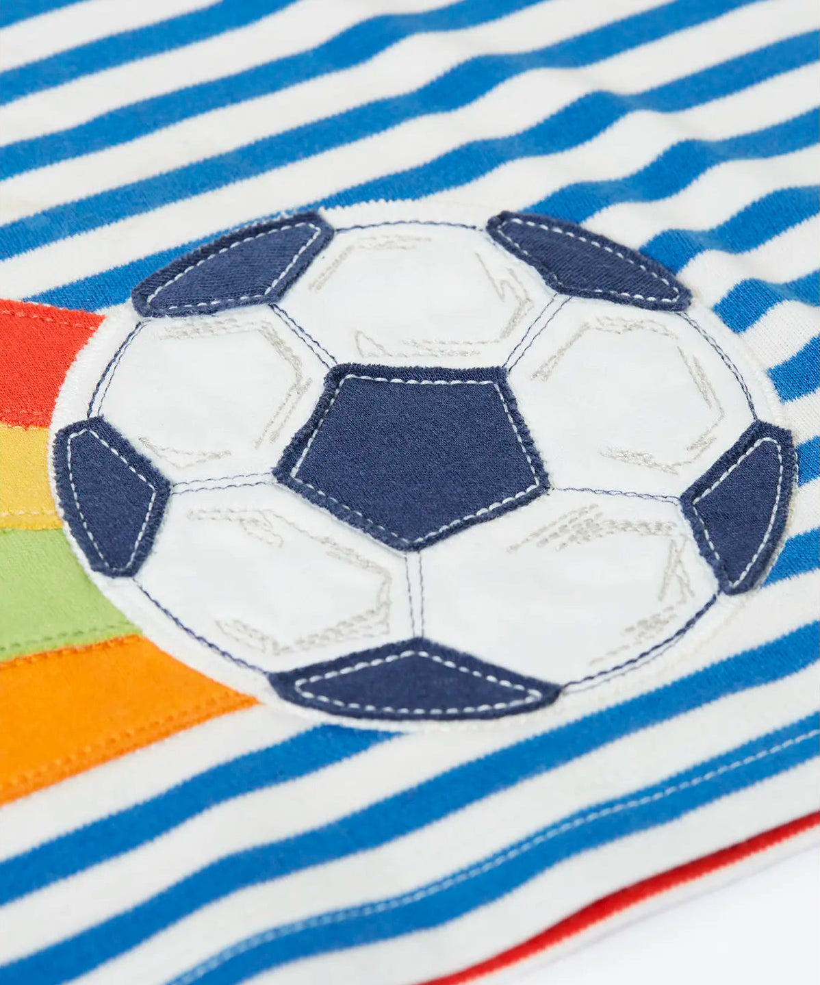 Close up of the football patch on the blue and white striped Frugi 100% organic cotton t-shirt