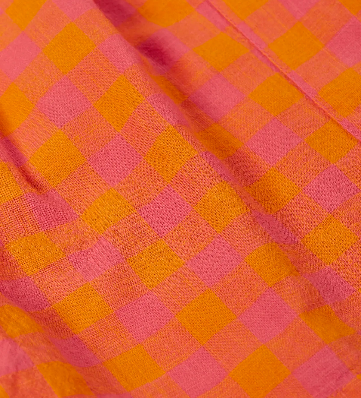 Close up of the Frugi 100% organic cotton Kai shorts showing the orange and pink check detail