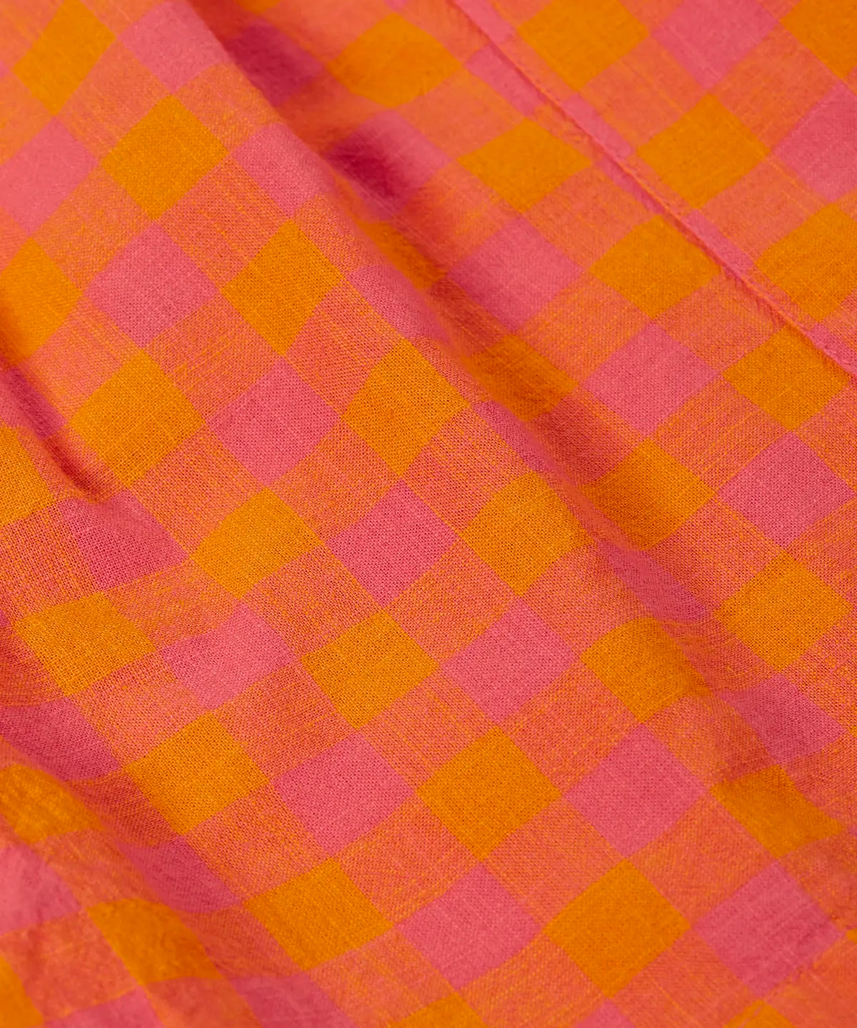 Close up of the Frugi 100% organic cotton Kai shorts showing the orange and pink check detail