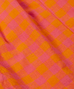 Close up of the Frugi 100% organic cotton Kai shorts showing the orange and pink check detail