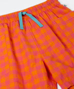 Close up of the Frugi 100% organic cotton Kai shorts showing the orange and pink check and blue waist tie detail