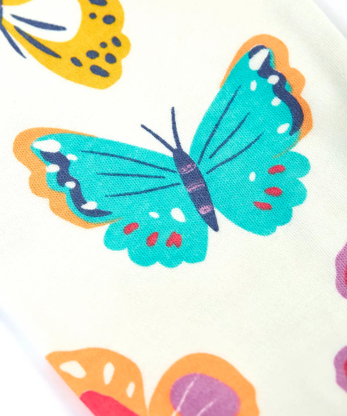 Close up of the repeating butterfly print on the Frugi 100% organic cotton Kernow pyjama set 
