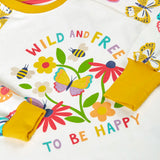 Frugi 100% organic cotton pyjama top  in white showing  a repeating butterfly print on the sleeves and a large wild and free floral design on the front