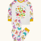 Frugi 100% organic cotton pyjama set in white showing  a repeating butterfly print on the trousers and large wild and free flower design on the top