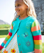 Child wearing Frugi 100% organic cotton cammie cardigan in light blue with rainbow striped sleeves showing spring embroideries on the front