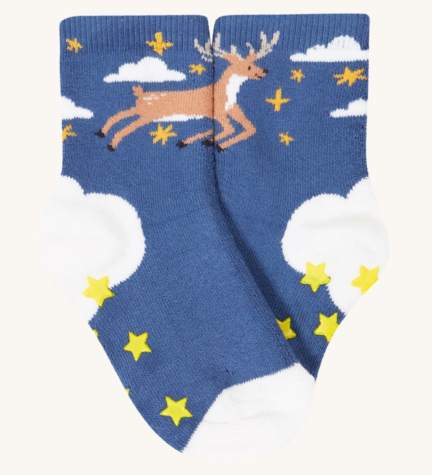 A close up of the blue sock with a reindeer design from the Frugi grippy 2 sock multipack in festive pals available at Babipur. Sock features yellow star grip panels on the sole.