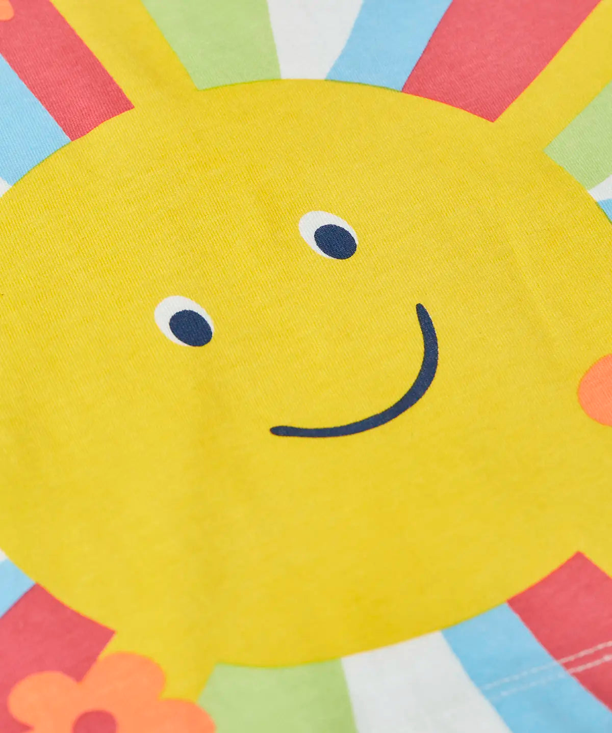 Close up of smiling sun on the Frugi 100% organic cotton light green raglan short sleeve t-shirt 