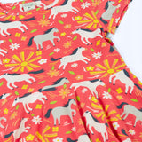 Frugi 100% spring skater dress in coral pink laid flat showing  repeating prints of grey and white horses