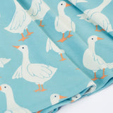 Close up of the repeating white goose print on the Frugi 100% organic cotton sunshine skater dress in light blue 