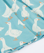 Close up of the repeating white goose print on the Frugi 100% organic cotton sunshine skater dress in light blue 
