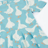 Frugi 100% organic cotton sunshine skater dress in light blue laid flat showing the repeating white goose print. 