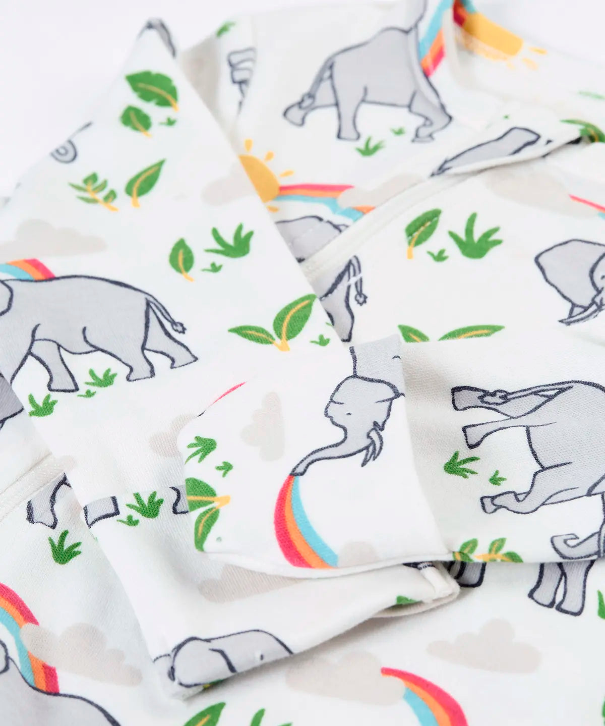 Frugi 100% organic cotton kimono style babygrow in white laid flat with a repeating elephant and rainbow print and cuff detail