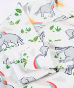 Frugi 100% organic cotton kimono style babygrow in white laid flat with a repeating elephant and rainbow print and cuff detail