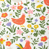 Close up of the Frugi 100% organic cotton white babygrow showing the repeating meadow inspired design