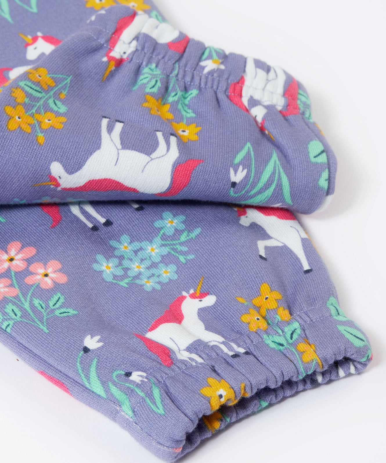 A close up of the elasticated cuffs on the Frugi malpas joggers in unicorn / floral available at Babipur. A GOTS organic cotton jogger in light purple with a playful unicorn and floral design. Features elasticated cuffs and side pockets.