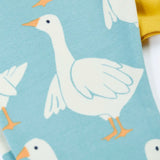 Close up of the light blue leggings from the Frugi bumblebee goose gaggle outfit showing the repeating goose print