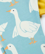 Close up of the light blue leggings from the Frugi bumblebee goose gaggle outfit showing the repeating goose print