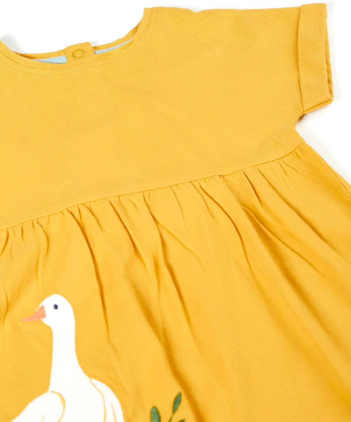 Close up of the yellow dress from the Frugi bumblebee goose gaggle outfit showing a goose patch on lower body