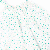 Close up of Frugi 100% organic cotton twirly dress in white showing the blue dots and shoulder straps
