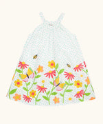 Frugi 100% organic cotton twirly dress in white with blue dots and repeating floral, bee and butterfly design on the bottom 