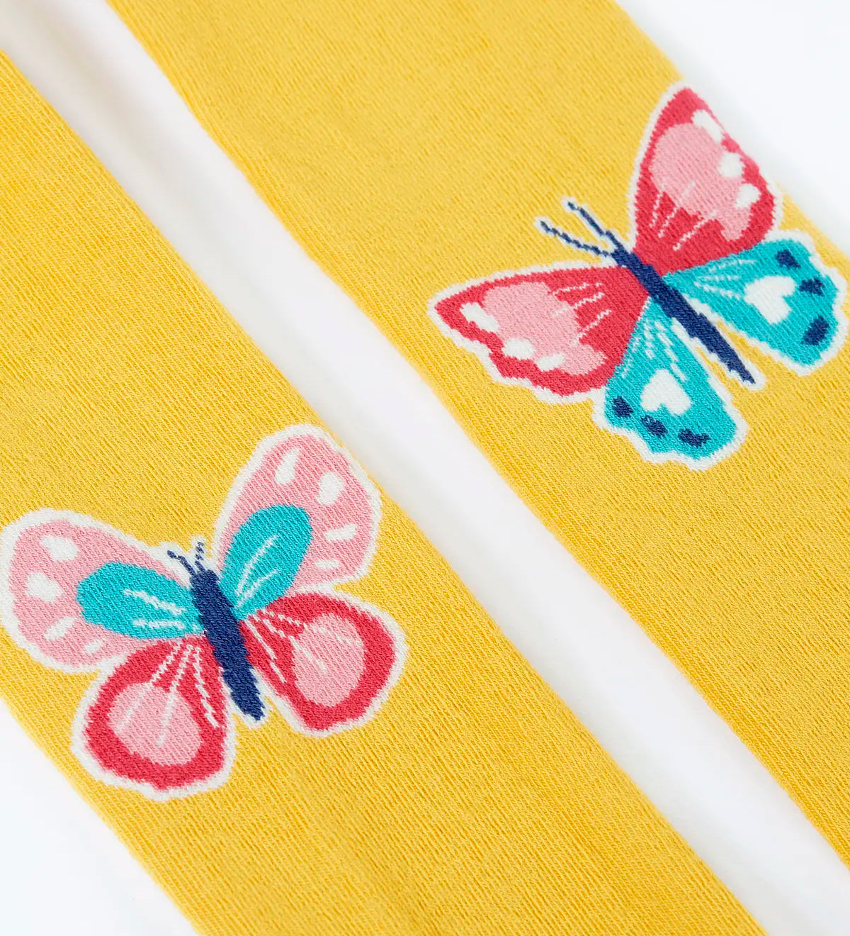 Close up of the butterfly design on the knees on the Frugi 100% organic cotton norah tights in yellow