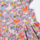 Frugi 100% organic cotton skater dress in violet purple laid flat showing the repeating meadow inspired print and frill detail