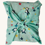 The Frugi GOTS-Certified organic cotton reusable gift wrap in Penguin Starry Sky design - a great eco-friendly alternative to wrapping paper 