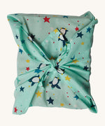 The Frugi GOTS-Certified organic cotton reusable gift wrap in Penguin Starry Sky design - a great eco-friendly alternative to wrapping paper 