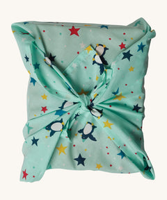 The Frugi GOTS-Certified organic cotton reusable gift wrap in Penguin Starry Sky design - a great eco-friendly alternative to wrapping paper 