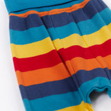 Frugi parsnip pants in big rainbow stripe available at Babipur. A GOTS organic cotton bottom in bold rainbow inspired striped design. Features blue elasticated cuffs.