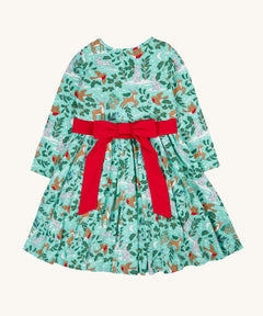 The back of the Frugi party skater dress in festive forest available at Babipur showing the red tie around the waist and tied in a festive inspired bow.