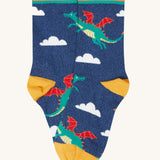 A close up of the blue sock with a green flying dragon design from the Frugi rock my socks 3 pack in dragon skies available at Babipur. 