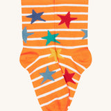 A close up of the orange and white striped sock with multicoloured stars from the Frugi rock my socks 3 pack in dragon skies available at Babipur. 