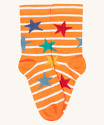 A close up of the orange and white striped sock with multicoloured stars from the Frugi rock my socks 3 pack in dragon skies available at Babipur. 