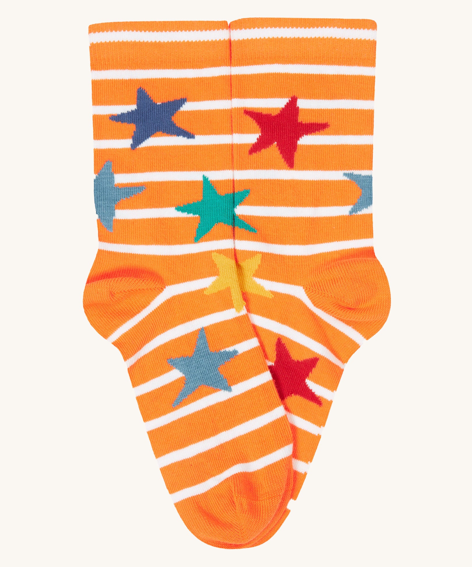 A close up of the orange and white striped sock with multicoloured stars from the Frugi rock my socks 3 pack in dragon skies available at Babipur. 