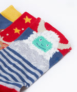 A close up of the yeti on one of the socks from the Frugi rock my socks 3 in festive multipack available at Babipur. GOTS socks in 3 different designs including a striped with a yeti, a red with reindeer and a blue sock with a cute robin design.