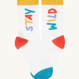 A close up of the white sock with the stay wild slogan from the Frugi rock my socks 3 pack in stay wild available at Babipur.